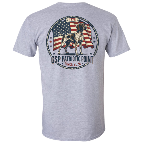 A sport gray short-sleeve t-shirt shown from the back, featuring a large circular graphic print with a dog standing in front of an American flag, surrounded by rope-style borders and the text 'GSP PATRIOTIC POINT SINCE 2026'.