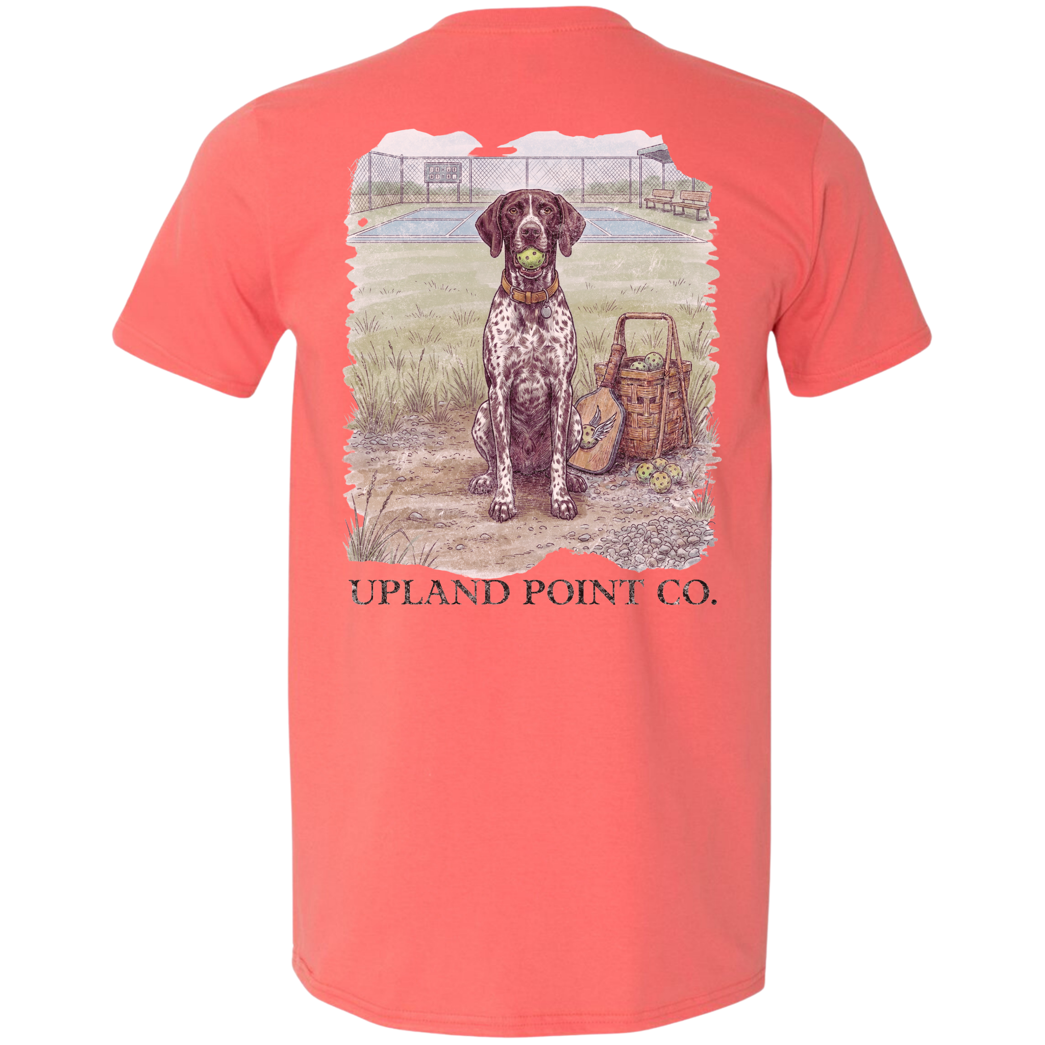 A coral short-sleeve t-shirt showing the back graphic, which features a detailed illustration of a black and white spotted dog holding a green ball next to a pickleball paddle and basket filled with pickleballs, with the text 'UPLAND POINT CO.' printed below